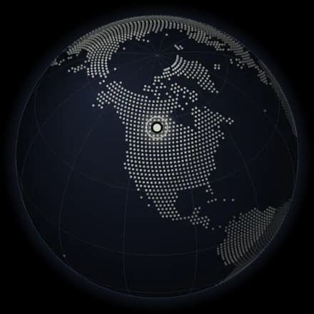 A globe with a pin on Canada